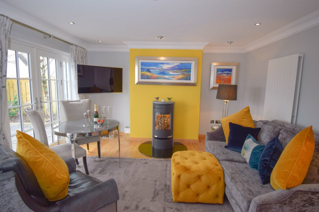The living area of our Outlander luxury Hideaway near Glencoe with its statement stove and cosy furnishings
